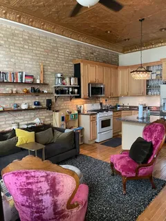 a kitchen with a table chairs stove and kitchen view
