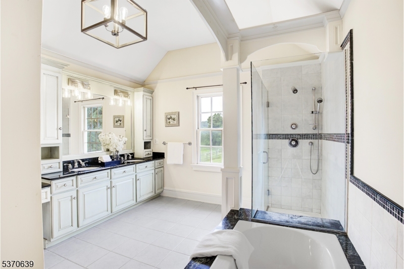 579 Goritz Road Asbury, NJ 08802 - Photo 28 of 50 a large bathroom with a tub sink and mirror