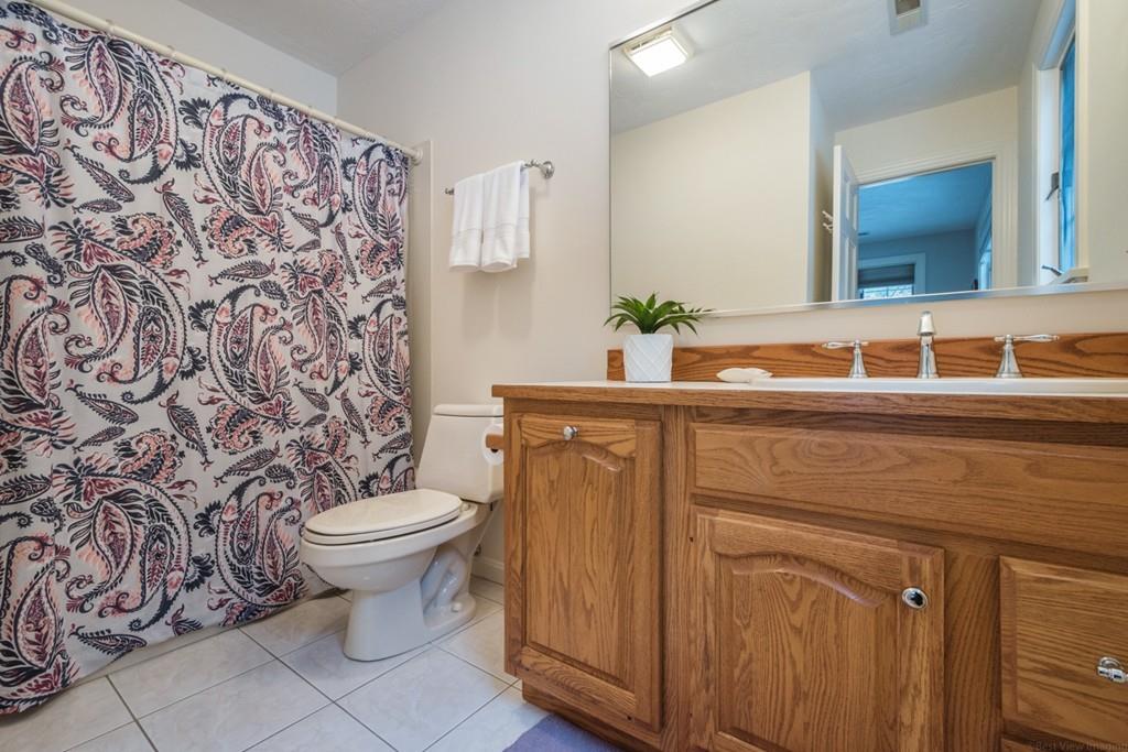 354 Burroughs Road Boxborough, MA 01719 - Photo 23 of 40 a bathroom with a toilet sink and mirror