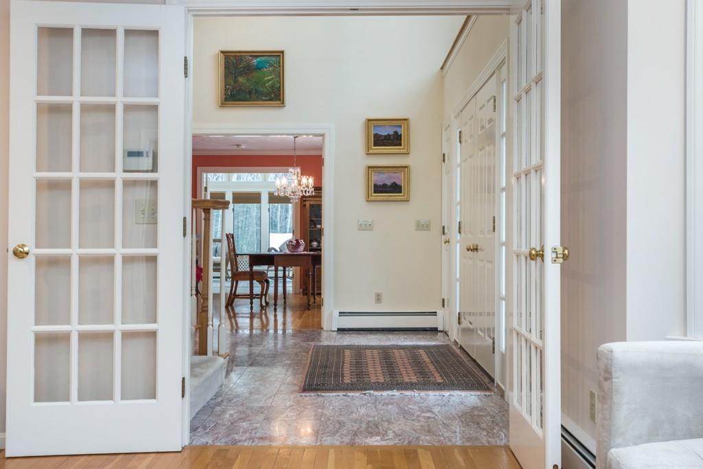 354 Burroughs Road Boxborough, MA 01719 - Photo 3 of 40 a view of a hallway with wooden floor and dining room