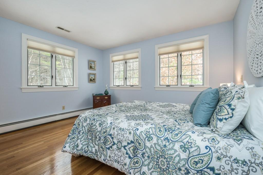 354 Burroughs Road Boxborough, MA 01719 - Photo 31 of 40 a bedroom with a bed and wooden floor
