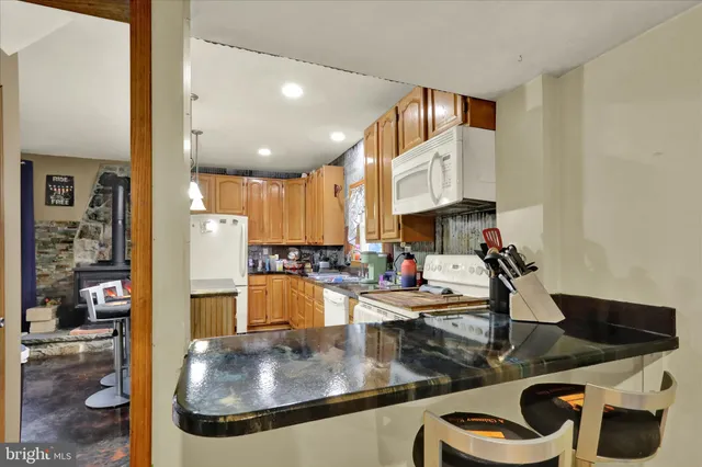 a kitchen with stainless steel appliances granite countertop a sink and cabinets