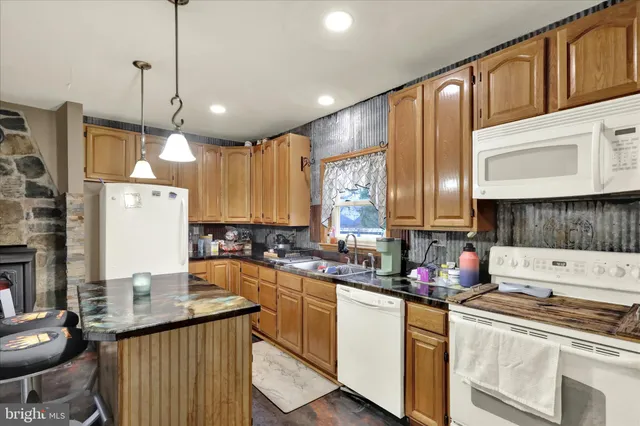 a kitchen with a stove a sink a refrigerator and cabinets