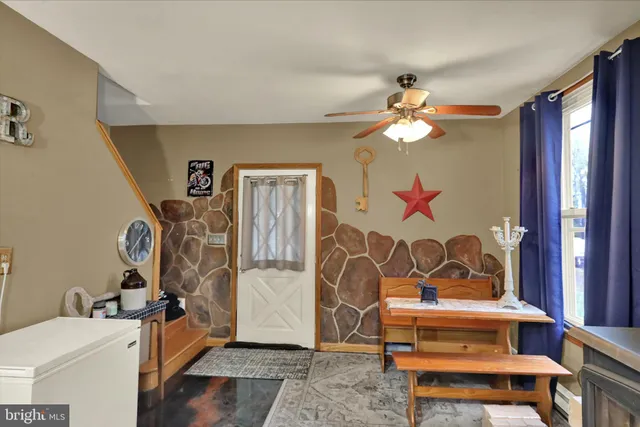 a bedroom with furniture and a chandelier fan