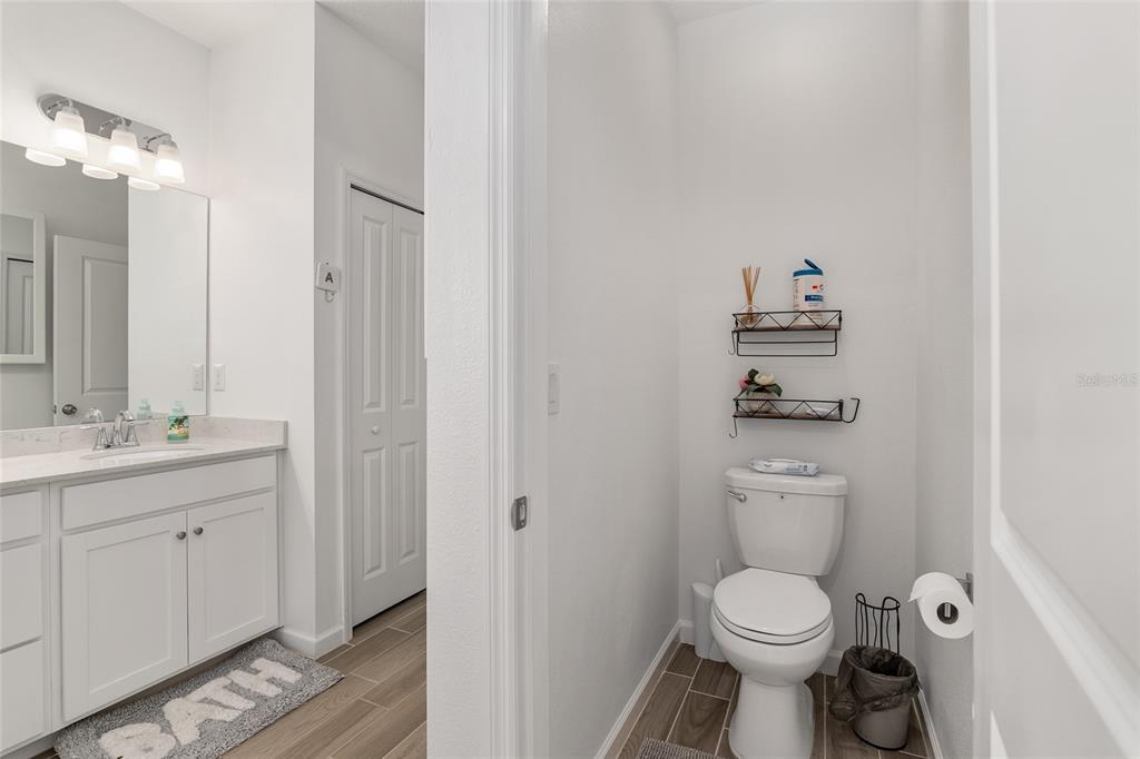 5688 Southwest 92nd Place Ocala, FL 34476 - Photo 33 of 54 a bathroom with a toilet a sink and a mirror