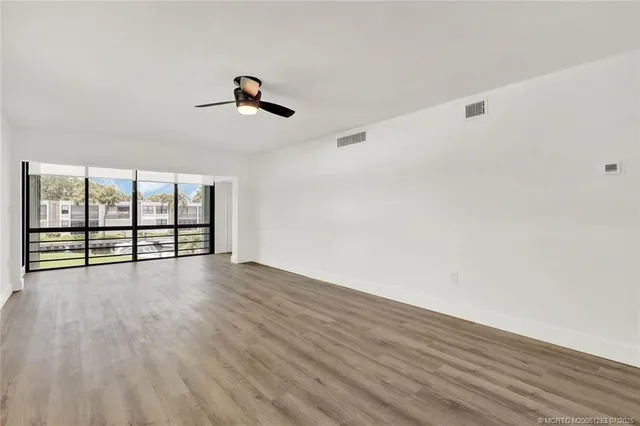 an empty room with large windows