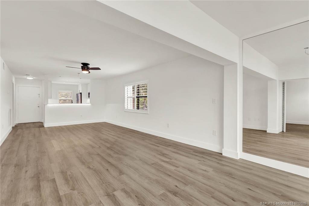 1950 Southwest Palm City Road, Unit 3201 Stuart, FL 34994 - Photo 16 of 51 a view of an empty room with wooden floor and a window