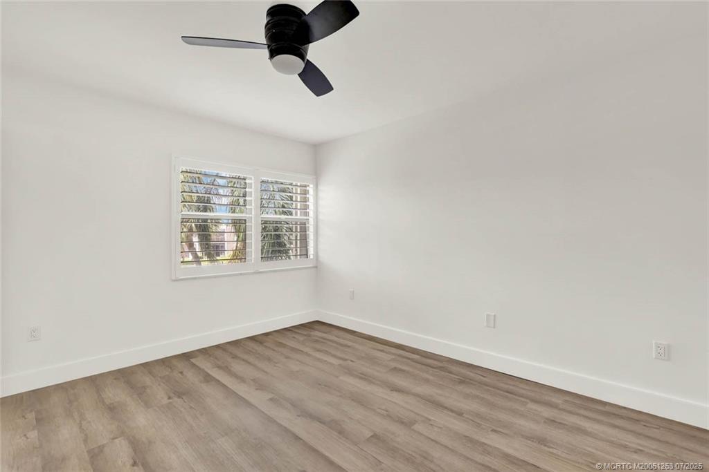 1950 Southwest Palm City Road, Unit 3201 Stuart, FL 34994 - Photo 25 of 51 wooden floor in an empty room with a window