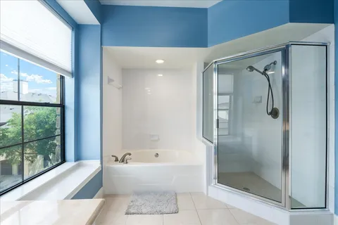 a bathroom with a bathtub and a shower