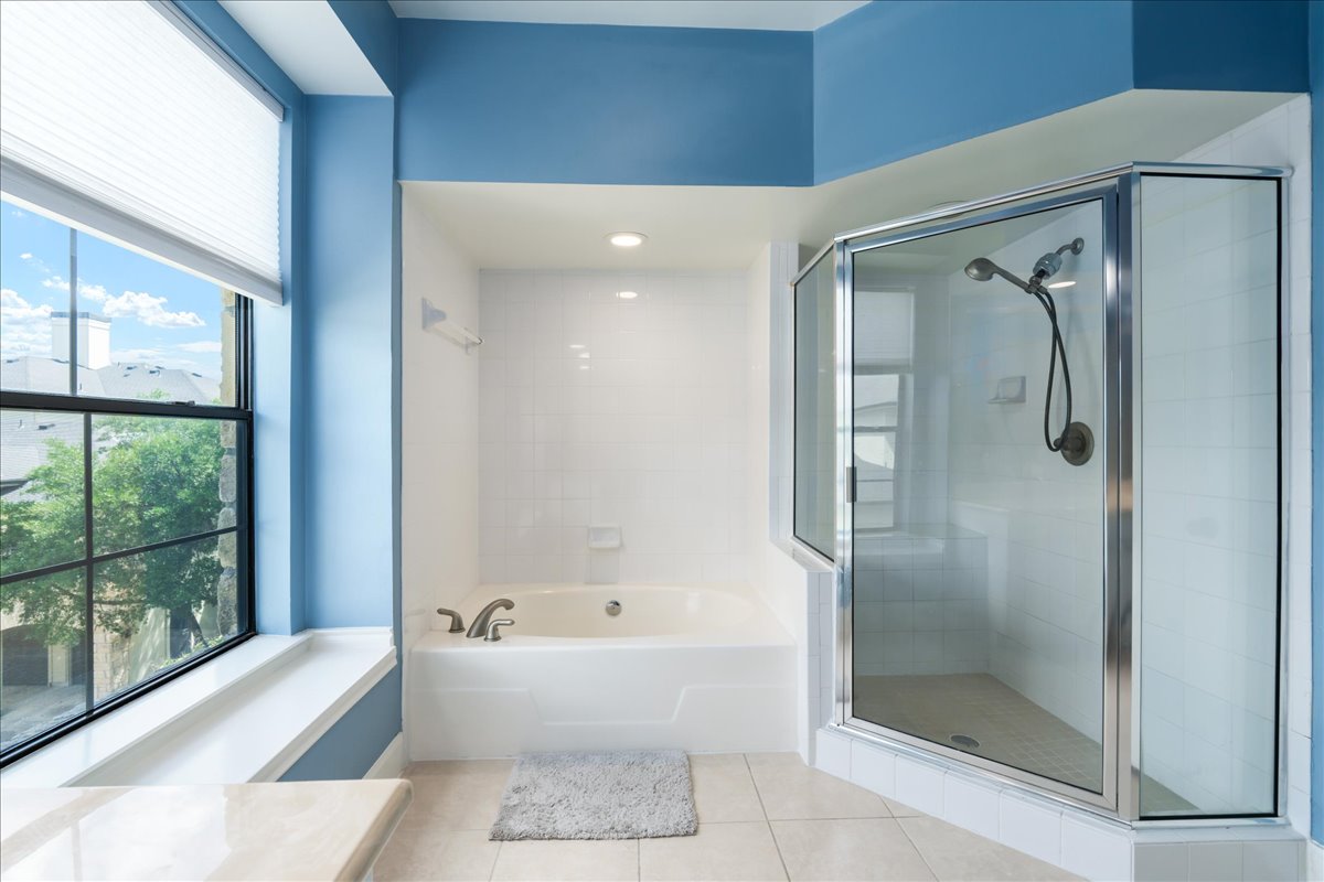 7701 Rialto Boulevard, Unit 91 Austin, TX 78735 - Photo 23 of 39 a bathroom with a bathtub and a shower