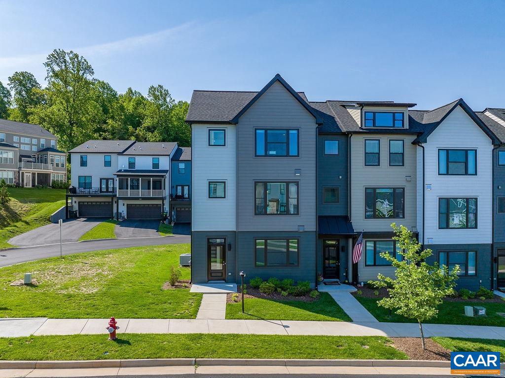 a front view of a residential apartment building with a yard