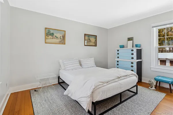 a bedroom with a bed and a night stand