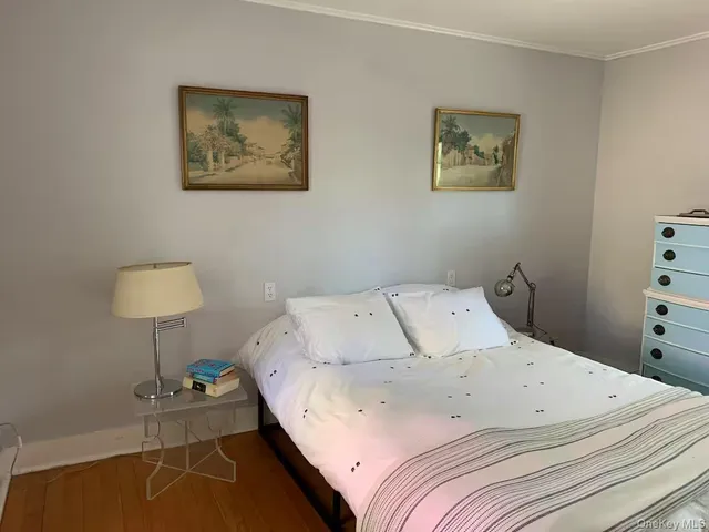 a bedroom with a bed and a lamp on table