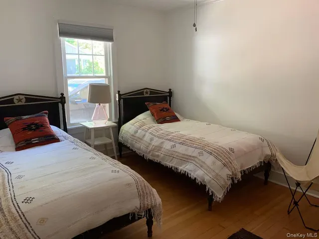 a bedroom with two beds and a window