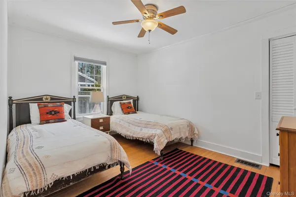 a bedroom with two beds and a chandelier