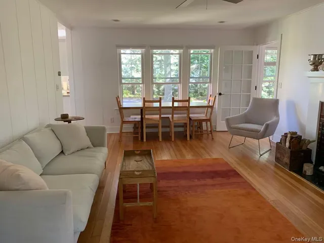 a living room with furniture dining table and a large window