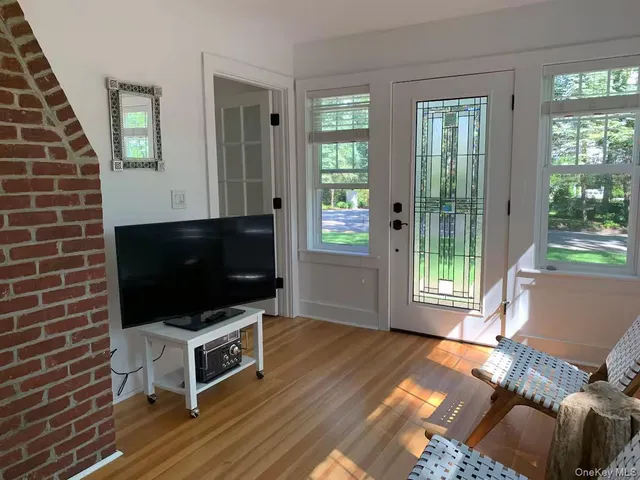 a living room with a flat screen tv and a fireplace