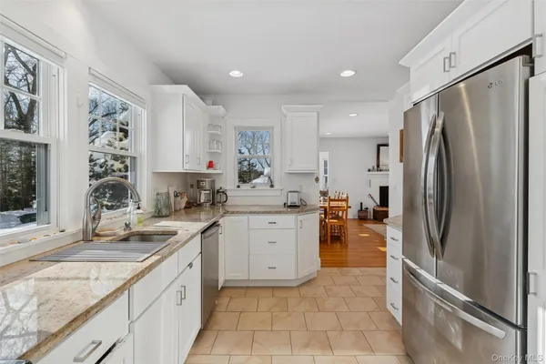 a kitchen with a refrigerator sink and cabinets