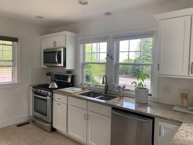 a kitchen with sink a window and appliances