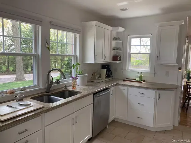 a kitchen with a sink stove and window
