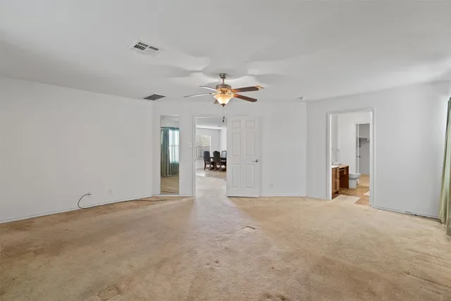 a view of a livingroom with a ceiling fan and window