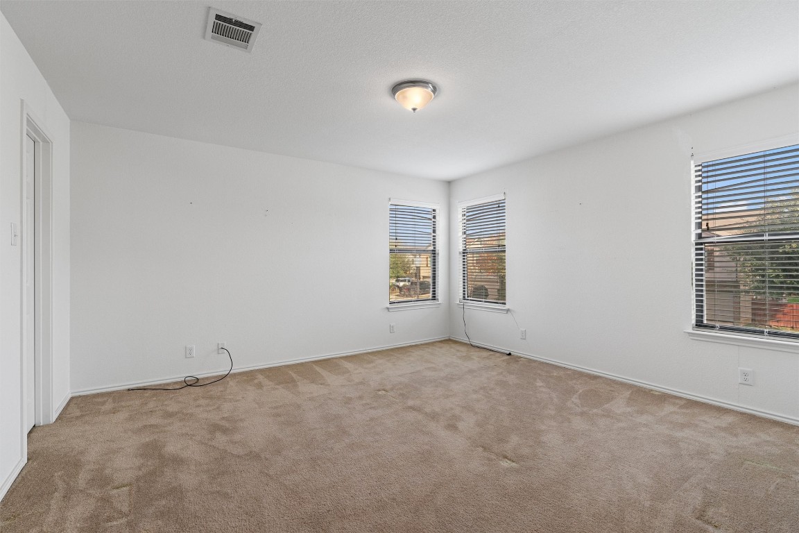 5700 Welsh Way Del Valle, TX 78617 - Photo 22 of 39 an empty room with windows