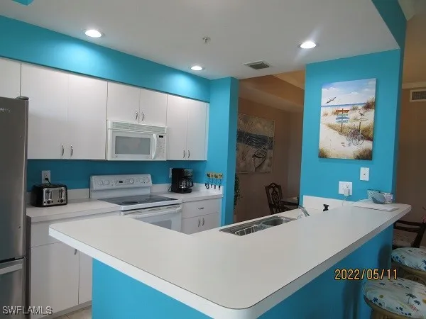 a kitchen that has a cabinets and a refrigerator