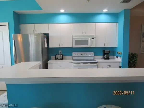 a kitchen with stainless steel appliances a refrigerator and a sink