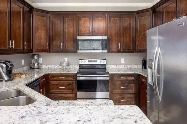 a kitchen with a sink stove and refrigerator
