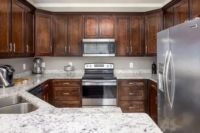 a kitchen with a sink stove and refrigerator