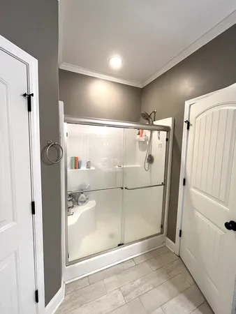 a bathroom with a shower and a sink
