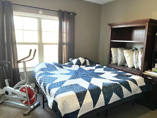 a bed sitting in a bedroom next to a window