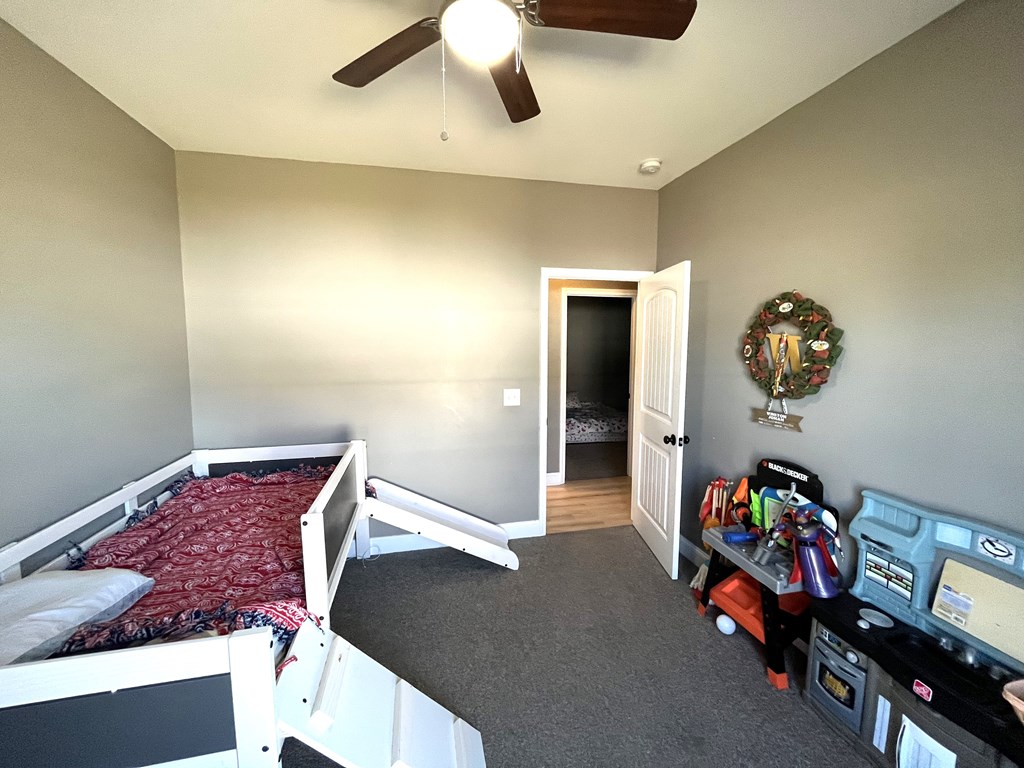 10 Maxwell Drive Fort Mitchell, AL 36856 - Photo 28 of 32 a bedroom with a bed and a chandelier