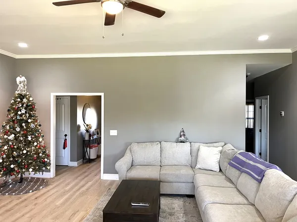 a living room with furniture and flowers