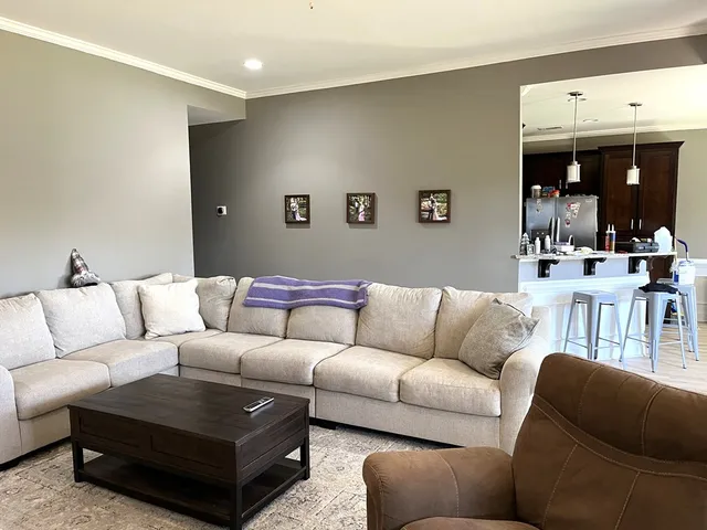 a living room with furniture a mirror and a couch