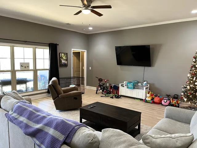 a living room with furniture and a flat screen tv