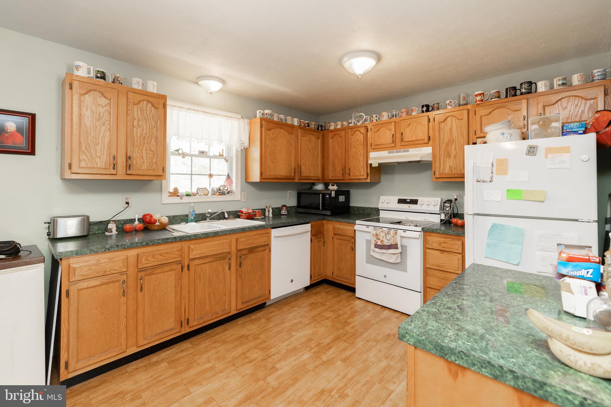 228 Sleepywoods Road Cross Junction, VA 22625 - Photo 9 of 34 a kitchen with granite countertop a sink stainless steel appliances and cabinets