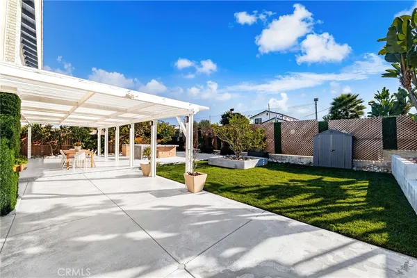 a outdoor space with lots of tables a garden and patio