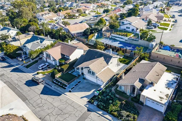 an aerial view of a residential houses with outdoor space and street view