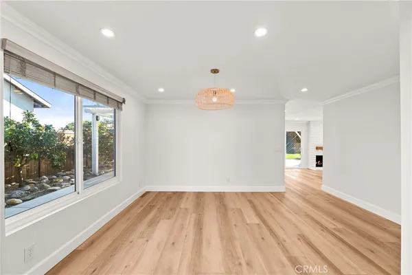a view of a room with wooden floor and a window