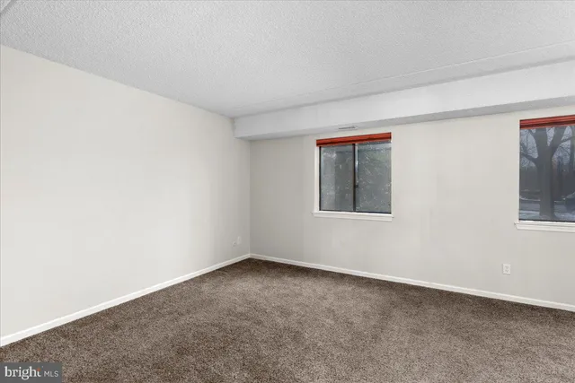 a kitchen with stainless steel appliances granite countertop a sink a stove a refrigerator and white cabinets