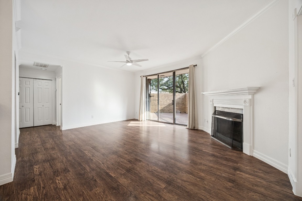 5200 Weslayan Street, Unit 101 Houston, TX 77005 - Photo 2 of 19 an empty room with wooden floor fireplace and windows