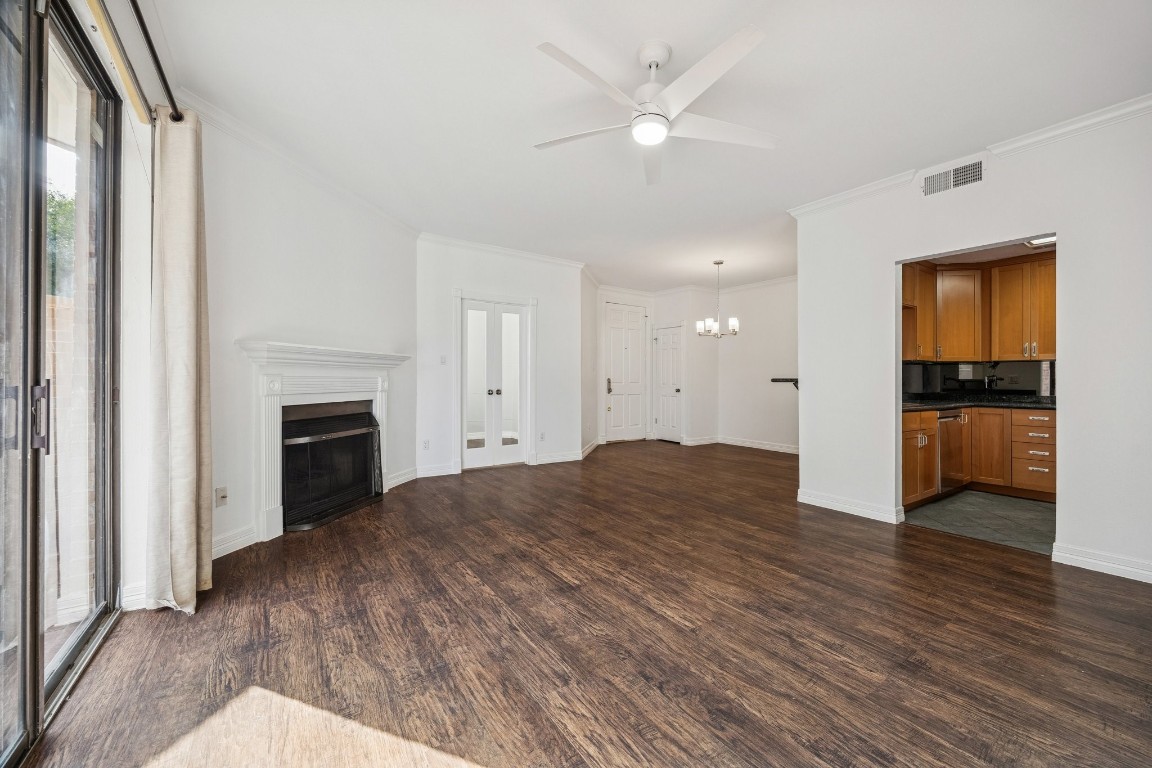 5200 Weslayan Street, Unit 101 Houston, TX 77005 - Photo 5 of 19 a view of empty room with kitchen view and a fireplace