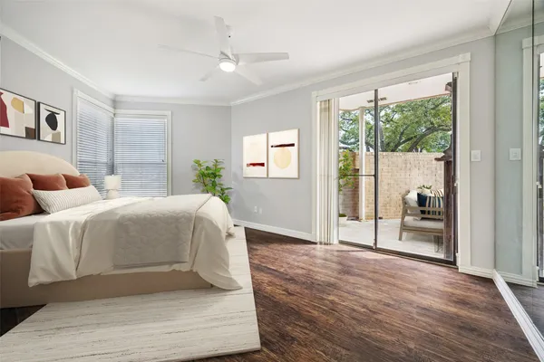 a spacious bedroom with a bed and glass door