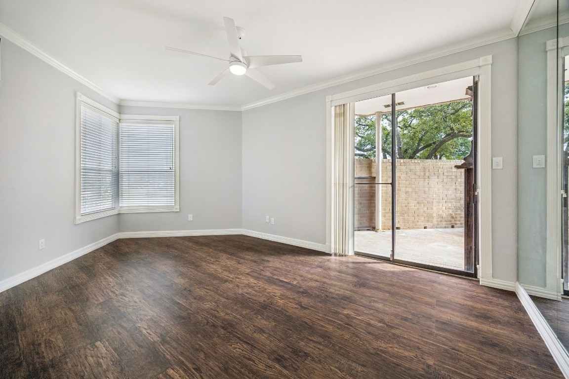5200 Weslayan Street, Unit 101 Houston, TX 77005 - Photo 10 of 19 a view of an empty room with wooden floor and a window