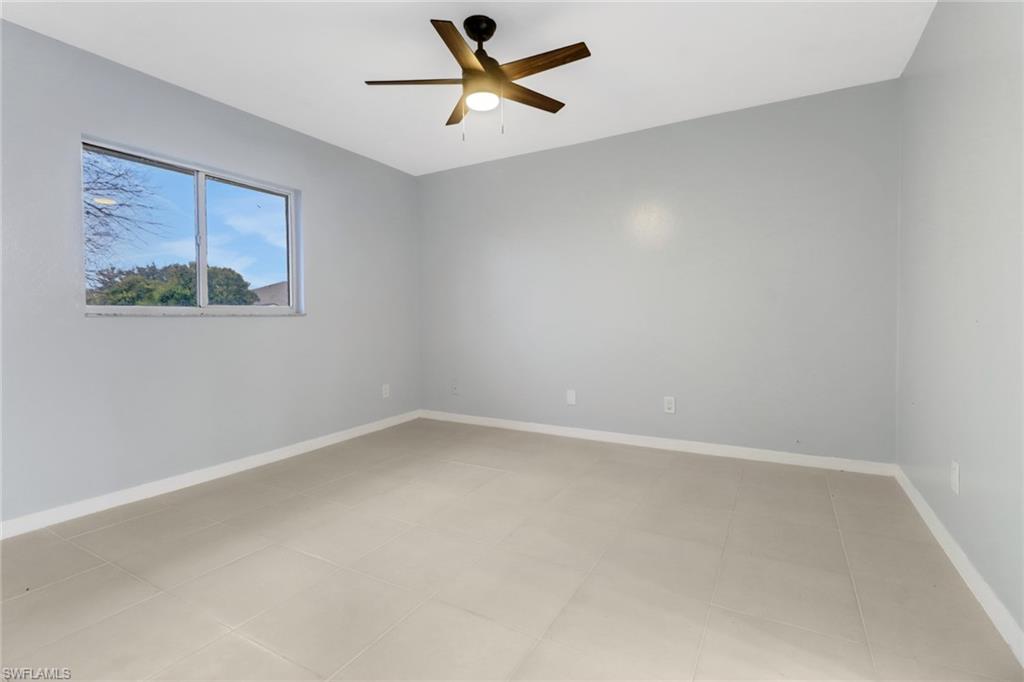 220 Ancona Street Fort Myers, FL 33913 - Photo 12 of 25 an empty room with a window and a fan