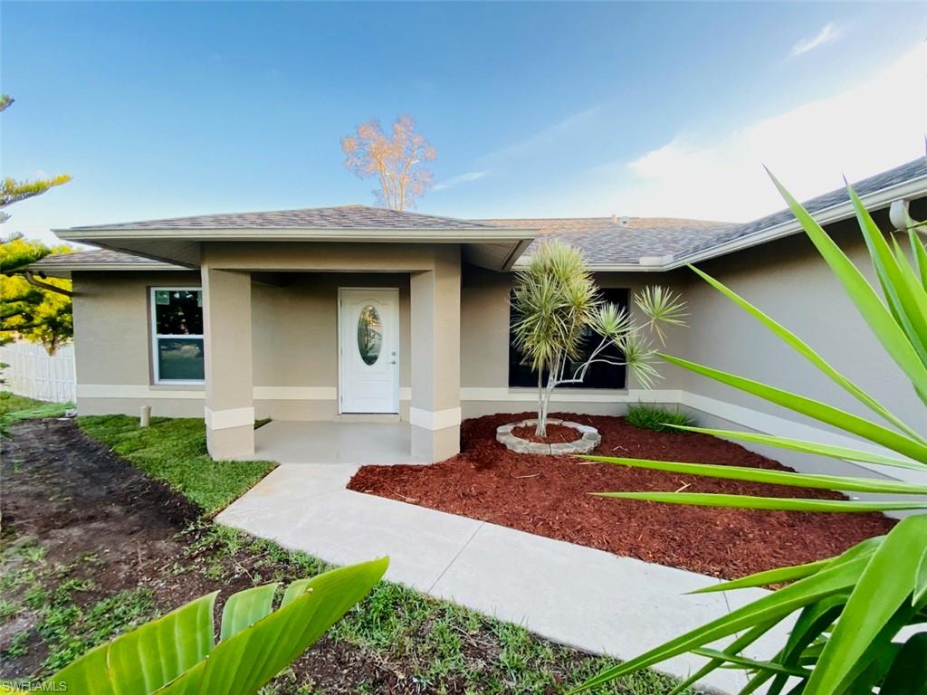 220 Ancona Street Fort Myers, FL 33913 - Photo 2 of 25 a front view of a house with garden