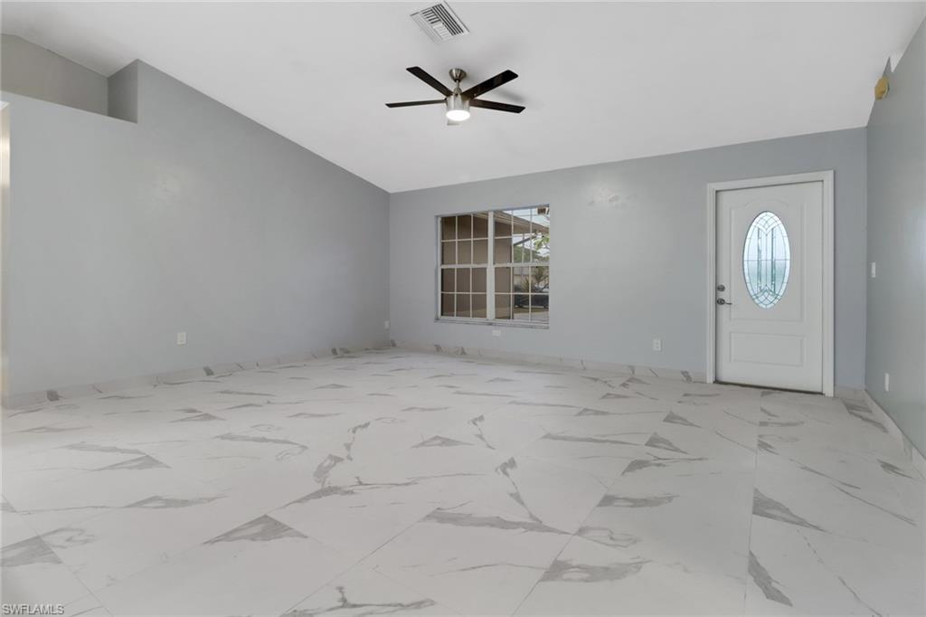 220 Ancona Street Fort Myers, FL 33913 - Photo 3 of 25 an empty room with windows and ceiling fan