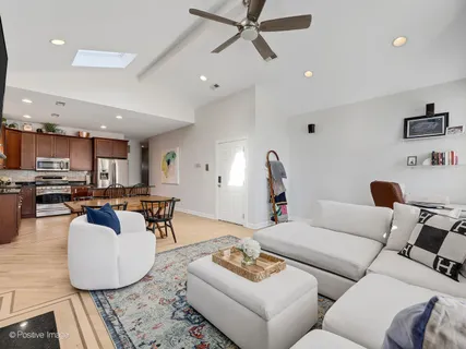 a living room with furniture and a view of kitchen