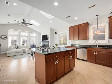 a kitchen with stainless steel appliances granite countertop a sink and a stove